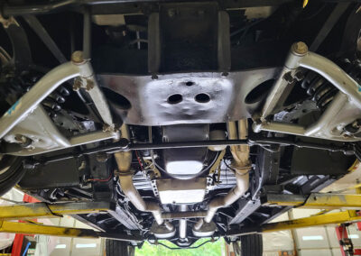 1955 Chevrolet Sedan in Yellow and White under carriage
